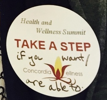 The image shows a sticker reading 'Health and Wellness Summit' and 'Take a step.' The words 'if you want / are able to' have been added in black marker.